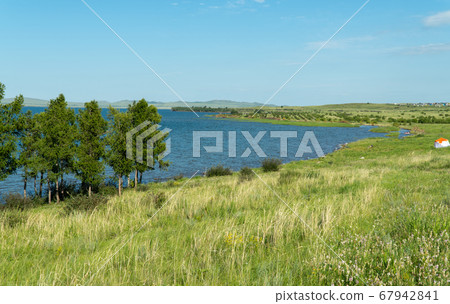 panorama of a beautiful lake with hilly shores. sunny summer day panorama of a beautiful lake with hilly shores. sunny summer day 67942841