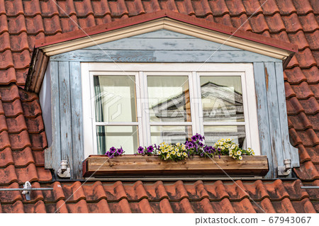 Skylight on a tiled roof of a traditional European Skylight on a tiled roof of a traditional European 67943067
