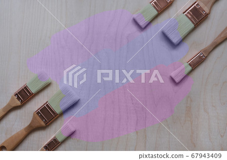 paint brushes on a plywood background 67943409