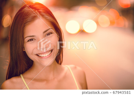 Asian girl smiling happy portrait on NYC city street. Sunset summer outdoor young woman enjoying life, healthy living Asian girl smiling happy portrait on NYC city street. Sunset summer outdoor young woman enjoying life, healthy living 67943581