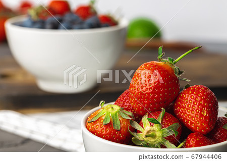 Close up photo of blueberries and strawberries Close up photo of blueberries and strawberries 67944406