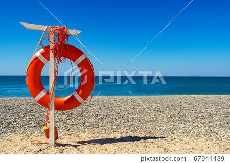 Lifebuoy on the beach against the sea 67944489