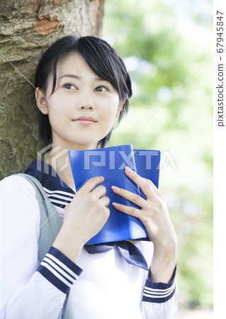 Junior high school girl reading a book 67945847