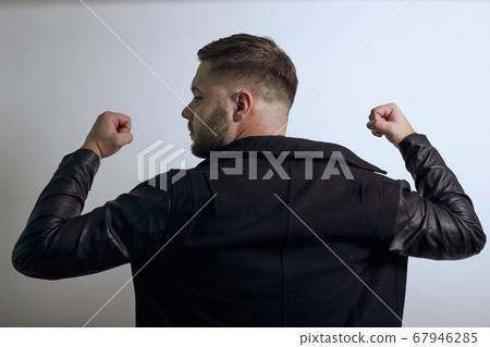 Solid Male Turned, Back, Shows Muscles On His Arms, Biceps. Powerful People Solid Male Turned, Back, Shows Muscles On His Arms, Biceps. Powerful People 67946285