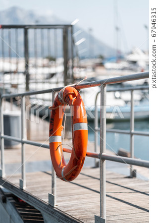 Orange rescue circle at the Yacht Club Rescue buoy 67946315