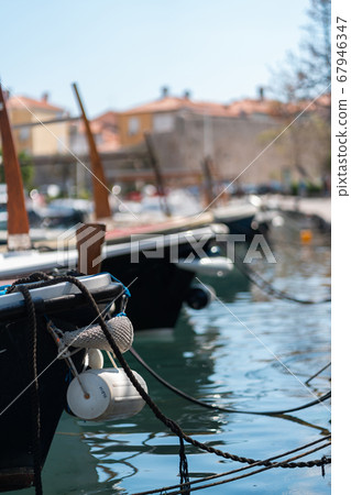 Fishing and tourist boats moored to the pier 67946347