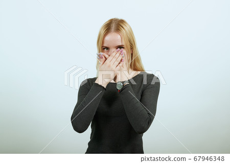 Upset Girl Covered Mouth With Her Hands, Is Silent. The Concept Of Suspicion 67946348