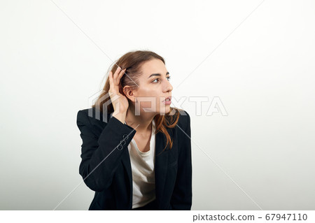 Eavesdropping, espionage, gossip, holding hand near head and looking away Eavesdropping, espionage, gossip, holding hand near head and looking away 67947110