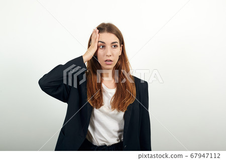 Holding her head with hand can not believe shocked and despair being in panic Holding her head with hand can not believe shocked and despair being in panic 67947112
