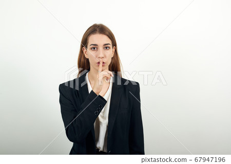 Index finger on lips, silence gesture, shhh quiet, voicelessness forefinger 67947196