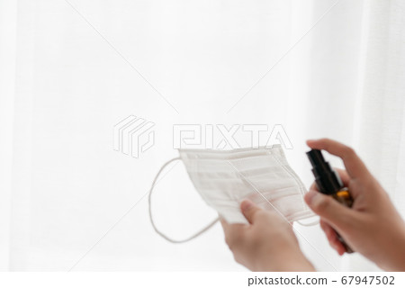 Disinfectant spray on mask 67947502