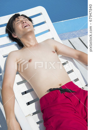 A man lying in a summer bed A man lying in a summer bed 67947840