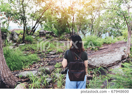 Backpacking woman in the forest - Happy woman 67948600