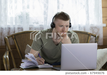 Caucasian man chatting with friends on social networks using laptop in home Caucasian man chatting with friends on social networks using laptop in home 67949876