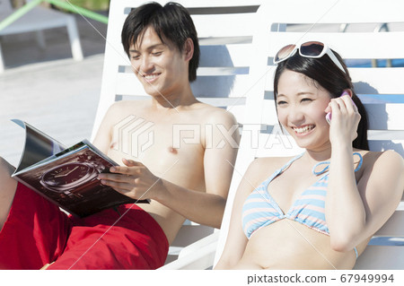 Couple relaxing on a summer bed Couple relaxing on a summer bed 67949994