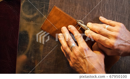 Craftsman working in workshop. 67950100