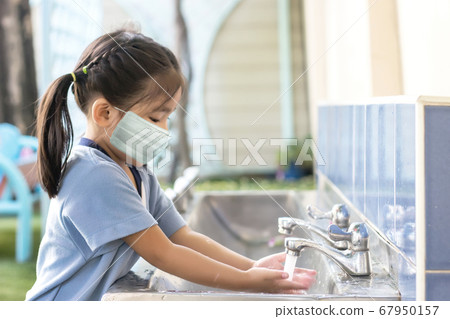 kid play outdoor with mask when back to school 67950157