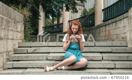 Ginger woman hold strobile in her hand. Ginger woman hold strobile in her hand. 67950216