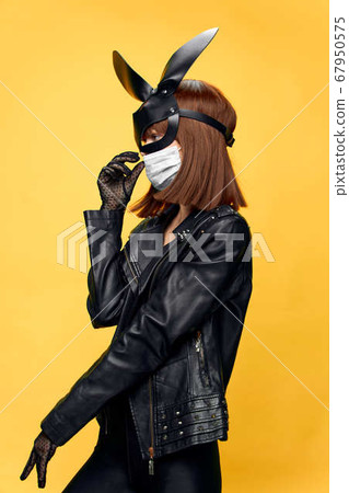 Female rabbit mask posing sexually in a medical mask from coronavirus 67950575