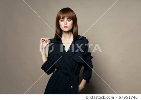 Strict look charming Woman in a black coat 67951746