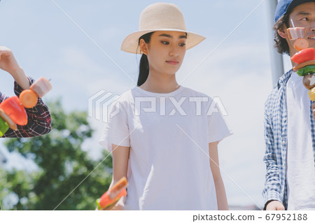 Young woman who is bad at barbecue Young woman who is bad at barbecue 67952188