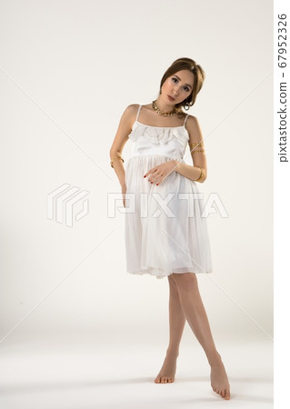 Graceful young woman in white dress 67952326