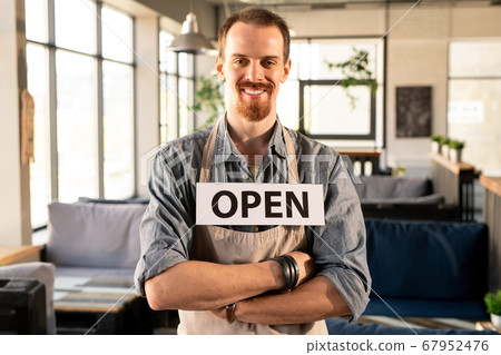 Coffee shop owner with Open sign Coffee shop owner with Open sign 67952476