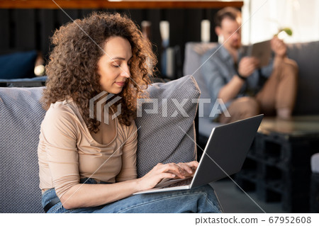 Smiling SMM manager working in cafe Smiling SMM manager working in cafe 67952608
