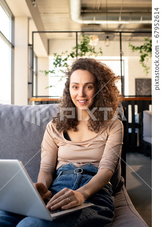 Smiling SMM manager working in cafe Smiling SMM manager working in cafe 67952614
