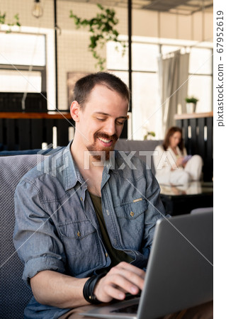 Handsome man working in cafe Handsome man working in cafe 67952619