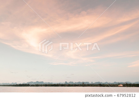 Warm tone sunset sky over Mae Khong river in Thailand - Nakhon Phanom 67952812