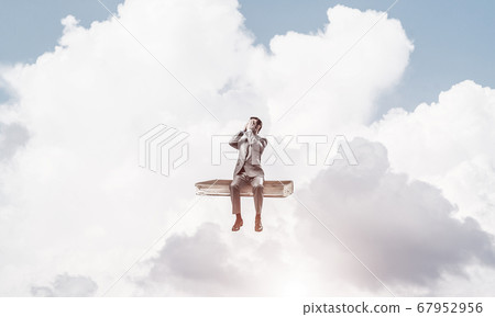 Young man on book in blue sky do not want to see anything Young man on book in blue sky do not want to see anything 67952956