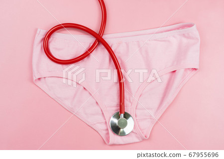 Pink underpants and red stethoscope  isolated on pink background.Woman hygiene, Concept of sanitary pad,critical days, menstruation,health care 67955696
