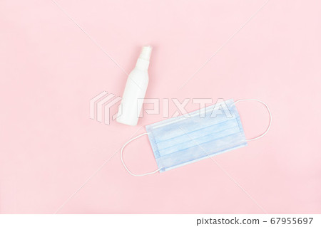 Medical face mask and alcohol spray bottle on pink background,health care concept 67955697