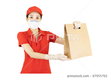 Delivery in red uniform isolated on white background.Courier in protective mask and medical gloves,concept delivers service under quarantine 67955702