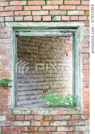 Window opening of an abandoned house without glass 67955969