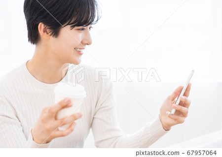 Woman looking at smartphone drink Woman looking at smartphone drink 67957064