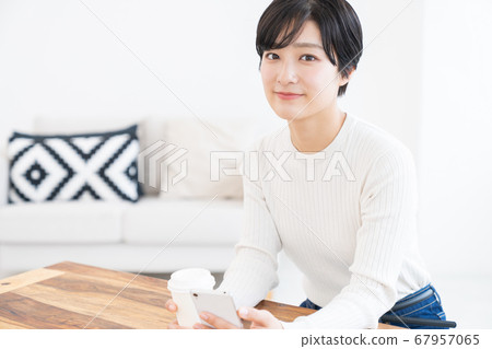 Woman looking at smartphone drink Woman looking at smartphone drink 67957065