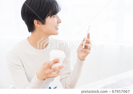 Woman looking at smartphone drink 67957067