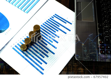 Double exposure of coin stack with city background Double exposure of coin stack with city background 67957402