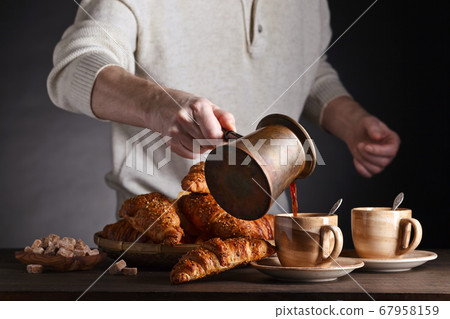 Breakfast with black coffee and fresh pastries 67958159
