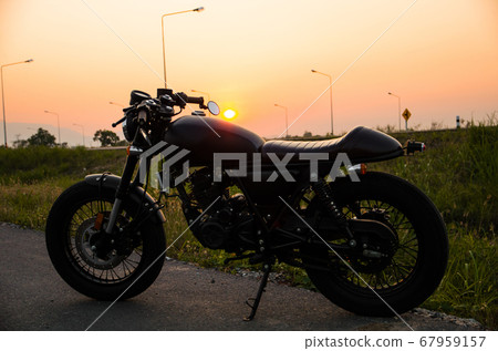 vintage motorcycle cafe racer style with sunset 67959157