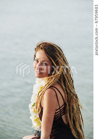 Woman enjoying sea breeze Woman enjoying sea breeze 67959683