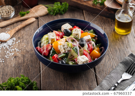 Closeup on fresh greek salad in a black bowl Closeup on fresh greek salad in a black bowl 67960337