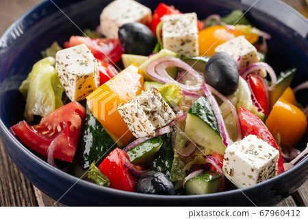 Closeup on fresh greek salad in a black bowl 67960412
