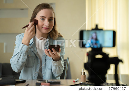 Female blogger making a video for her beauty blog on cosmetics. Female blogger making a video for her beauty blog on cosmetics. 67960417