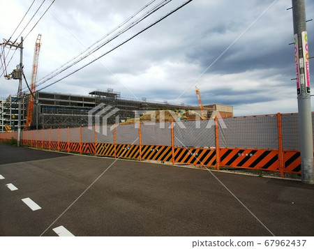 Beyond wide sidewalks and power lines, construction sites and large heavy machinery in large shopping malls hidden behind safety-first fences and curtains Beyond wide sidewalks and power lines, construction sites and large heavy machinery in large shopping malls hidden behind safety-first fences and curtains 67962437