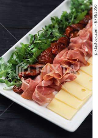 prosciutto cheese and sun-dried tomatoes 67963050