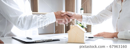 Real estate agent and customers shaking hands Real estate agent and customers shaking hands 67963160