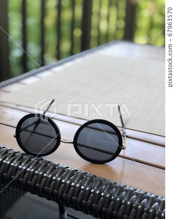 Round sunglasses on the desk Round sunglasses on the desk 67963570